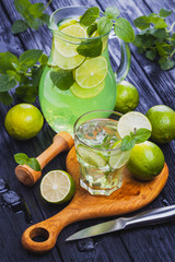 lemonade mojito in a glass on a black wooden background
