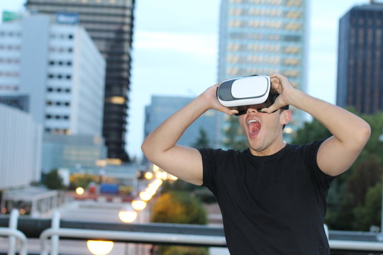 Male using virtual reality glasses in the city 