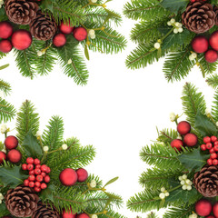 Christmas decorative background border with holly ivy, mistletoe, fir, red bauble decorations and pine cones on white.