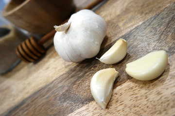 Garlic, honey, and other kitchen utensils illustrates a herbal medicine preparations