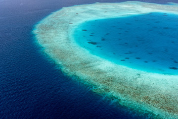 Colorful aerial photo of Maldives atolls and deep blue sea