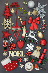 Christmas symbols with gold noel sign, new and old fashioned bauble decorations, holly, mistletoe, fir and  mince pie on grey background. 