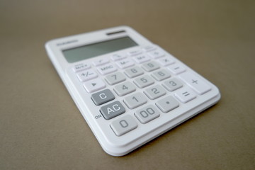 Calculator on brown background