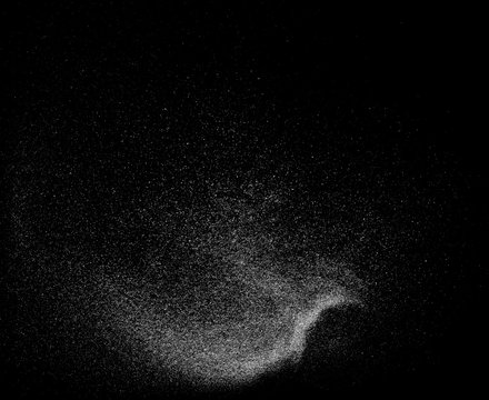 Powder explosion isolated on black background, abstract dust overlay texture 