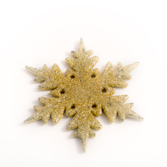 Gold colored christmas star on white background