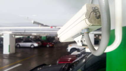 Security equipment concept. Closeup CCTV camera monitoring in the cars park. CCTV camera surveillance on car parking Safety system area control with copy space.