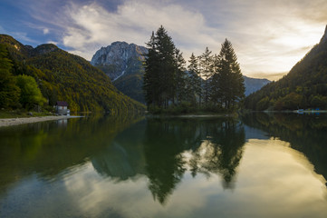 romantic sunset over a mountain lake in the Italian alps, Lago di Predil