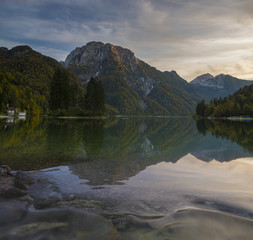 Fototapeta na wymiar romantic sunset over a mountain lake in the Italian alps, Lago di Predil