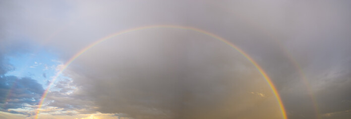 stormy sky with colorful rainbow