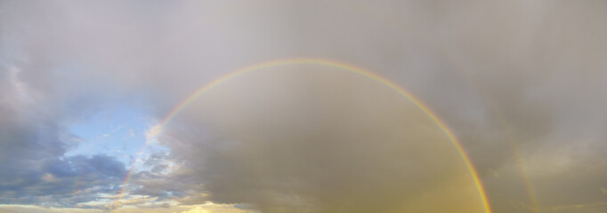 stormy sky with colorful rainbow