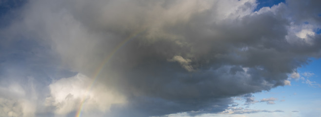 Fototapeta premium stormy sky with colorful rainbow