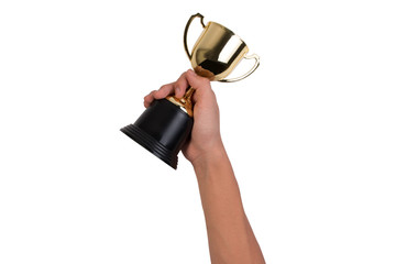 Asian boy holding a gold trophy cup for first place champion award isolated on white background. Boy holding up a gold trophy cup as a winner in school competition.