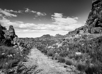 A dirt road winds through rocky outcrops in the Cederberg Wilderness Area, South Africa