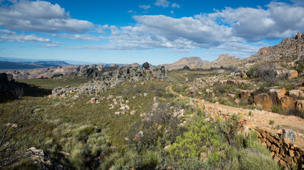 Fototapeta na wymiar A dirt road winds through rocky outcrops in the Cederberg Wilderness Area, South Africa