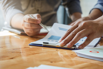 Business team meeting and discussing project plan. Businessmen discussing together in meeting room. Professional investor working with business project together. Finance managers task.