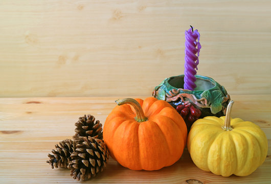 Minimalist Seasonal Decorations with Vibrant Color Ripe Pumpkins, Pine Cones and Purple Candle in Grape Motif Holder 