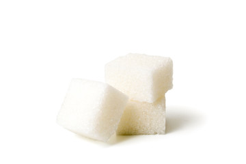 Three cubes of sugar on white