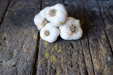 heads of garlic on a dark wooden table