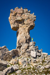 A hiker stands on the Maltese Cross rock formation in the Cederberg Wilderness Area