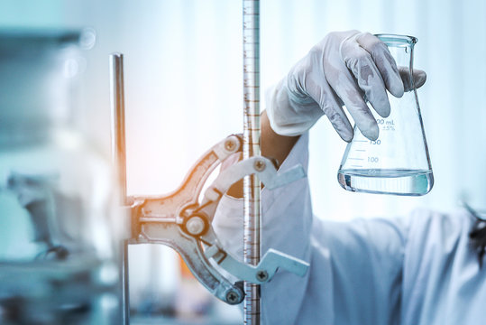 microscope with lab glassware, science laboratory research and development concept