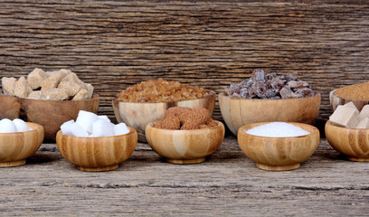 Different types of sugar in a many bowls on table