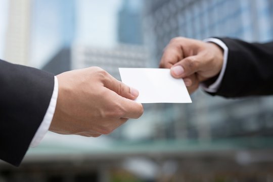 business man in hand hold show business cards blank white card mock up filing give to connect business contacts. Business branding concept. - Powered by Adobe