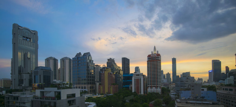 Panorama view of Bangkok business district skyline at dusk.