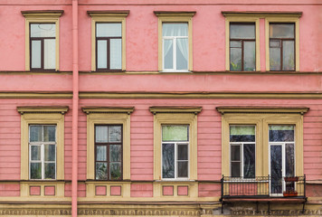 Obraz premium Several windows in a row and balcony on facade of urban apartment building front view, St. Petersburg, Russia