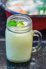 Glass of lemon lime blended summer drink with mint topping