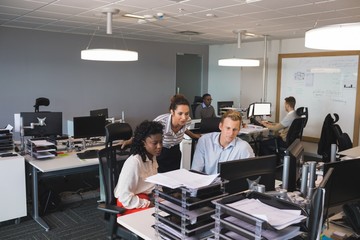 Business colleagues discussing at desk