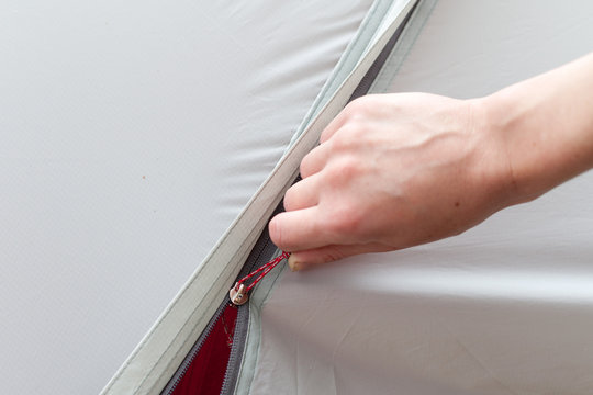 Girl Hand Unzip The Entry Of Camping Tent On Rainfly