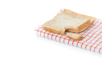 Bitten sliced bread on towel ,isolated white background..A bite taken out of a sliced bread, Whole wheat and organic ingredient bread,healthy eating concept..