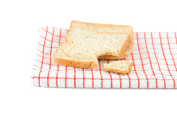 Bitten sliced bread on towel ,isolated white background..A bite taken out of a sliced bread, Whole wheat and organic ingredient bread,healthy eating concept..