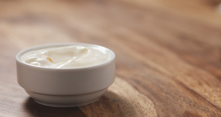 peach yogurt in white bowl on table