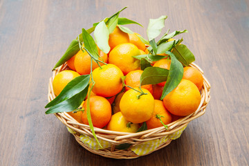fresh mandarin oranges fruit with leaves on wooden table