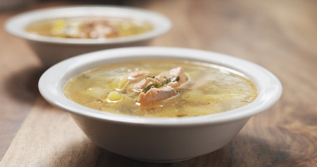 closeup fish soup with salmon on wood table