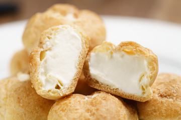 profiteroles on plate closeup one sliced