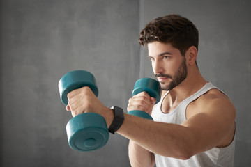 Young man using dumbbells