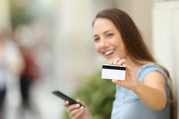 Happy on line buyer showing a credit card