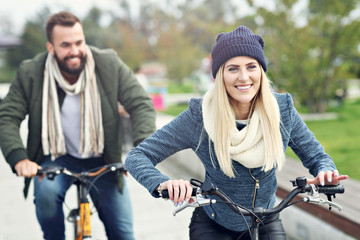 Young couple riding bikes and having fun in the city