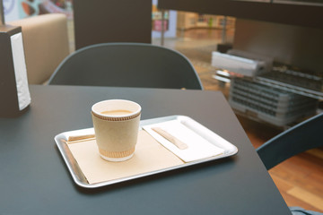serving coffee in a paper cup