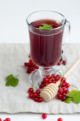 warming red berry drink, tea, mors, red currant berries on white background. © ytochka89