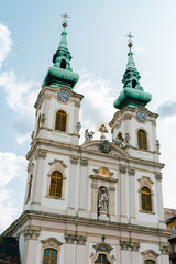 Fototapeta na wymiar Street view and facade of the Saint Anne church in Budapest the capital city of Hungary