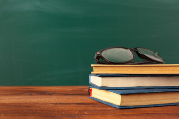 Books on Desk, Chalkboard Background