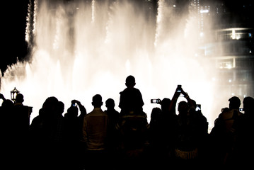 Naklejka premium People recording and enjoying the Dubai fountain show