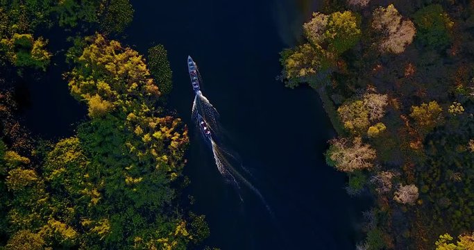 Two boats with people swim along the river. People jump in the water. Aerial image in the Pantanal Biome. Beautiful landscape of Mato Grosso do Sul state, Central-Western Brazil. 