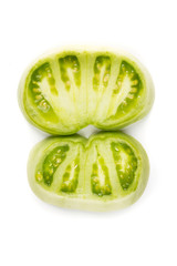 Fresh sliced green tomatoes isolated on a white background