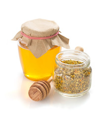 jar of honey and bee pollen on white background