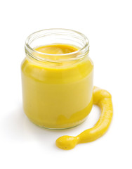 mustard sauce in jar on white