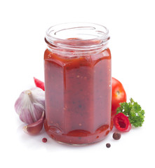 tomato sauce in glass jar on white